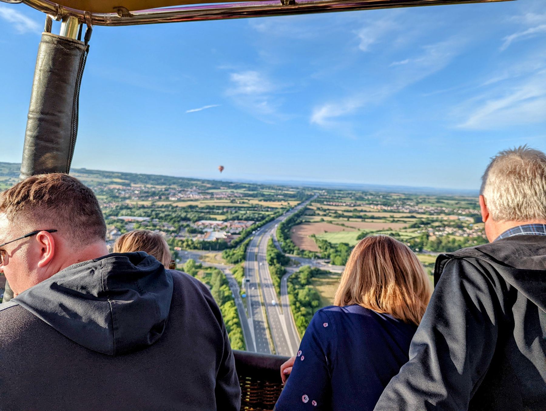 Passengers looking out from the basket over the Somerset countryside