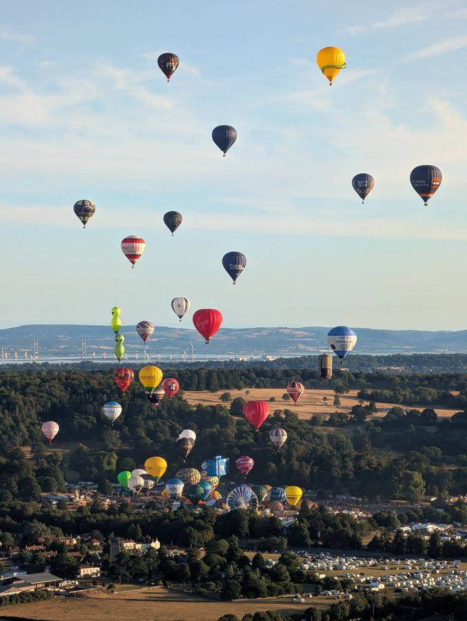 Balloons rising over Ashton Court in the Bristol Balloon Fiesta mass ascent